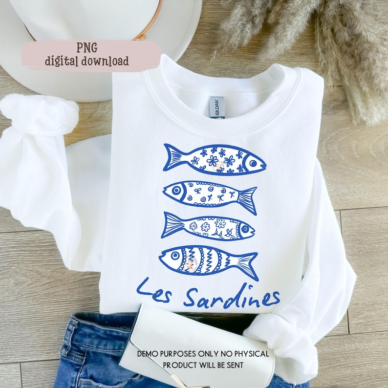 May include: White sweatshirt featuring four blue fish illustrations with floral and patterned details. The text "Les Sardines" is below the fish. The words "PNG digital download" are in the upper left corner.