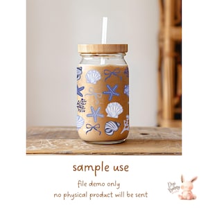 May include: A clear glass mason jar with a wooden lid and a straw. The jar is filled with a light brown liquid and decorated with a blue and white seashell pattern. The text "sample use" is written below the jar. The text "file demo only" is written below "sample use". The text "no physical product will be sent" is written below "file demo only".