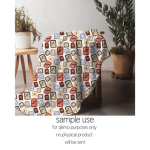 May include: A white blanket with a repeating pattern of postage stamp designs in red, yellow, blue, and brown. The blanket is draped over a wooden chair. The text "sample use" and other disclaimers are at the bottom.