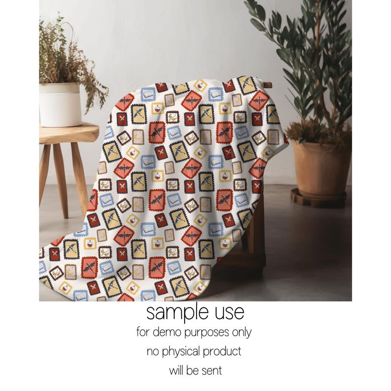 May include: A white blanket with a repeating pattern of postage stamp designs in red, yellow, blue, and brown. The blanket is draped over a wooden chair. The text "sample use" and other disclaimers are at the bottom.