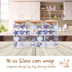 May include: Three 16 ounce glass can wraps with a blue and white seashell and starfish design. The wraps have a wooden lid and a straw.