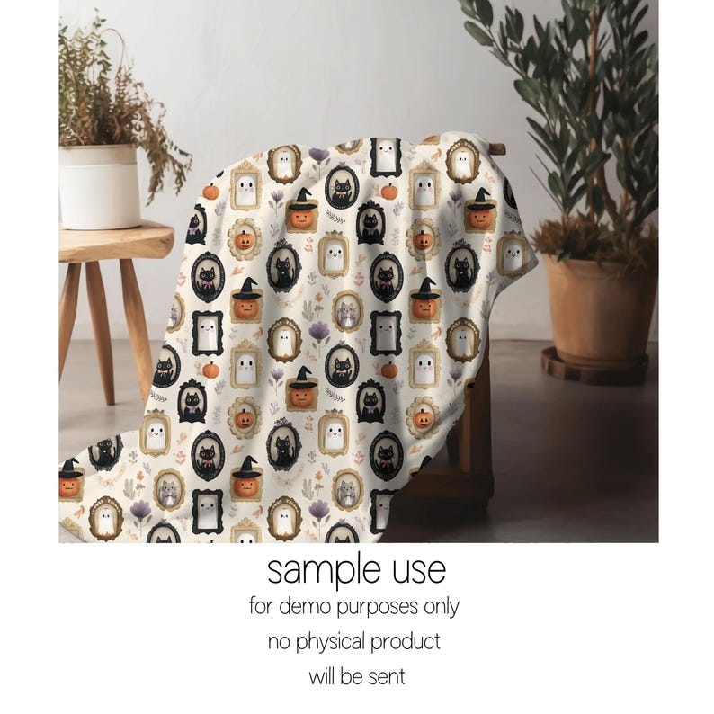 May include: A cream-colored Halloween-themed blanket featuring framed illustrations of ghosts, black cats, pumpkins, and floral accents. The blanket is draped over a wooden chair. The text "sample use for demo purposes only no physical product will be sent" is visible.