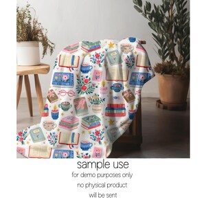 May include: A white blanket with a repeating pattern of books, flowers, teacups, and candles. The blanket is draped over a wooden chair. The text "sample use for demo purposes only no physical product will be sent" is printed at the bottom.