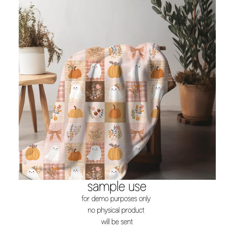 May include: A soft throw blanket featuring a repeating grid pattern of autumn-themed illustrations including orange pumpkins, white ghosts, floral bouquets, and tan bows in shades of cream, brown, and orange on a light-colored background.