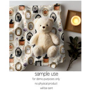 May include: A cream-colored teddy bear sits on a Halloween-themed fabric. The fabric features framed illustrations of pumpkins, ghosts, and black cats. The text "sample use for demo purposes only no physical product will be sent" is visible.