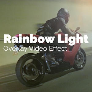 May include: A red sports motorcycle in motion inside a tunnel. The text "Rainbow Light Overlay Video Effect" is displayed in white. The rider is wearing a helmet and dark clothing.