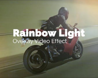 May include: A red sport motorcycle speeding through a tunnel. The text "Rainbow Light Overlay Video Effect" is displayed in white. The rider is wearing a helmet and dark clothing.