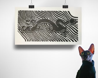 May include: A black and white print of a dragon on a striped background. The print is hanging on a white wall. A hairless cat is looking at the print.