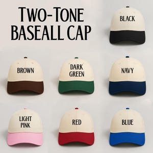 May include: A collection of two-tone baseball caps in various colors, including black, brown, dark green, navy, light pink, red, and blue. Each cap features a cream-colored crown and a colored brim, with the color name printed on the crown.