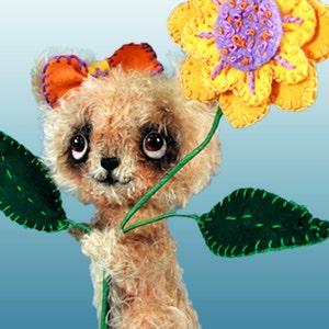 May include: A plush teddy bear with brown fur and big eyes holds a yellow felt flower with a purple centre. The flower is attached to a green felt stem with two green leaves.
