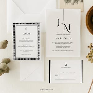 May include: Elegant wedding invitation suite featuring a minimalist design. The set includes a main invitation, details card, and RSVP card, all in white with black text and accents. The invitation features the initials "JM" and the names "Jamie & Mark".