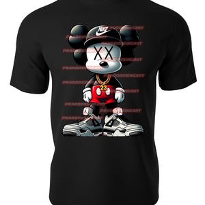 May include: Black t-shirt with a cartoon illustration of Mickey Mouse wearing a Nike hat, a gold chain, red shorts, and white and black sneakers. The Mickey Mouse illustration has an X for eyes and the text "23" on his chest.