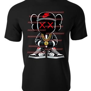 May include: Black t-shirt featuring a cartoon character wearing a black and white checked shirt, a gold chain, a black hat with a red "X" and a white Nike swoosh, and black and white trainers. The character has a red "X" for eyes.