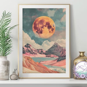 May include: A digital art print featuring a large, orange moon over a landscape of pink and brown mountains with a blue lake in the valley. The moon has a textured surface and is surrounded by white clouds.