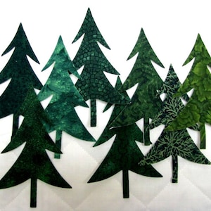 May include: A set of nine green felt Christmas tree cutouts. The trees are various sizes and have different patterns.