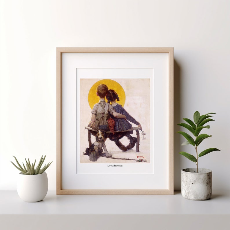 May include: Framed print of a vintage illustration depicting two children sitting on a bench, with a dog and fishing pole. The artwork features a warm color palette with a yellow sun in the background. The title "Little Spooners" is visible.