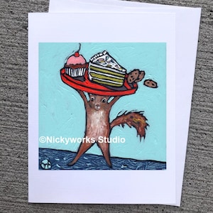 May include: Greeting card featuring an illustration of a squirrel holding a red tray with a cupcake, cake slice, and cookies. The background is light blue with a textured appearance. The card has the text "Nickyworks Studio".