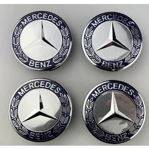 May include: Four silver Mercedes-Benz wheel center caps with a blue and white logo. The logo features a three-pointed star and the words "Mercedes" and "Benz".