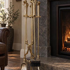 May include: A gold-toned metal fireplace tool set featuring a stand with a base and four long-handled implements. The handles are shaped like bird heads, and the set includes a shovel, a brush with black bristles, and metal tongs.