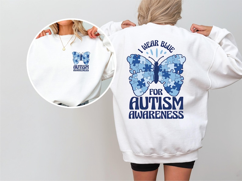 May include: White sweatshirt with a blue butterfly made of puzzle pieces on the back. The butterfly has the text "I wear blue for autism awareness" on it. The front of the sweatshirt has a smaller blue butterfly with the text "Autism awareness" on it.