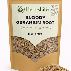 May include: A brown paper bag labeled "HerbsLife" containing "Bloody Geranium Root" (Geranium sanguineum). The bag is partially open, revealing the dried root pieces. A small pile of the root is in front of the bag. The word "Organic" is printed on the bag.