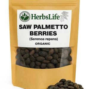 May include: A brown paper bag with a clear window showing dark brown saw palmetto berries. The bag has the text "HerbsLife" and "SAW PALMETTO BERRIES (Serenoa repens) ORGANIC" in white. A small pile of berries is in front.