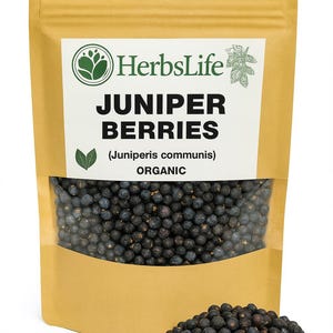 May include: A package of organic juniper berries with the HerbsLife logo. The package is tan with a clear window showing the dark blue-black berries. A small pile of berries sits in front of the package. Text on the package reads "Juniper Berries".