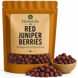 May include: A brown paper bag with a clear window showing red juniper berries. The bag has a label with the text "HerbsLife Red Juniper Berries (Juniperus Oxycedrus)". A small wooden bowl and a pile of berries are next to the bag.