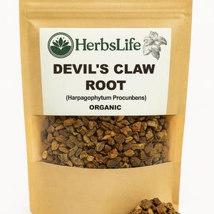 May include: A brown paper bag with a clear window displaying Devil's Claw Root. The bag has a white label with the text "HerbsLife" and "DEVIL'S CLAW ROOT (Harpagophytum Procumbens) ORGANIC". A small pile of the root is visible at the bottom.