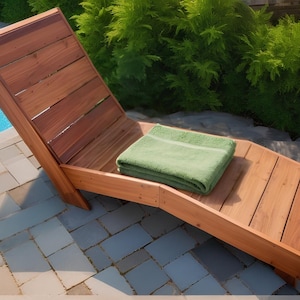 May include: A wooden lounge chair with a green towel on it. The chair is made of natural wood and has a slatted design. The chair is sitting on a patio next to a swimming pool.