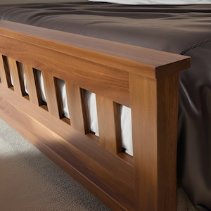 May include: Close-up of a wooden bed frame with a slatted headboard. The headboard is made of dark brown wood with a natural finish. The slats are evenly spaced and create a geometric pattern.