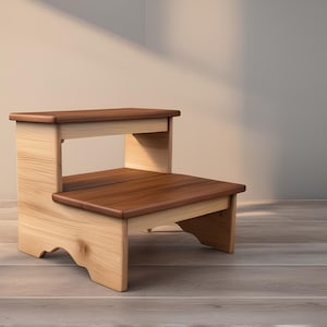 May include: A two-step wooden stool with a natural wood finish. The top step is a darker brown wood. The stool has a decorative scalloped edge.