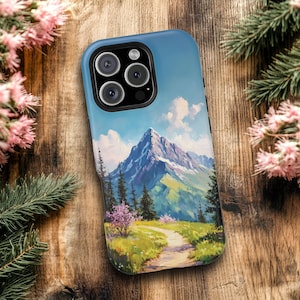 May include: A black phone case with a colorful mountain scene. The case has a camera lens cutout and a blue sky with white clouds.