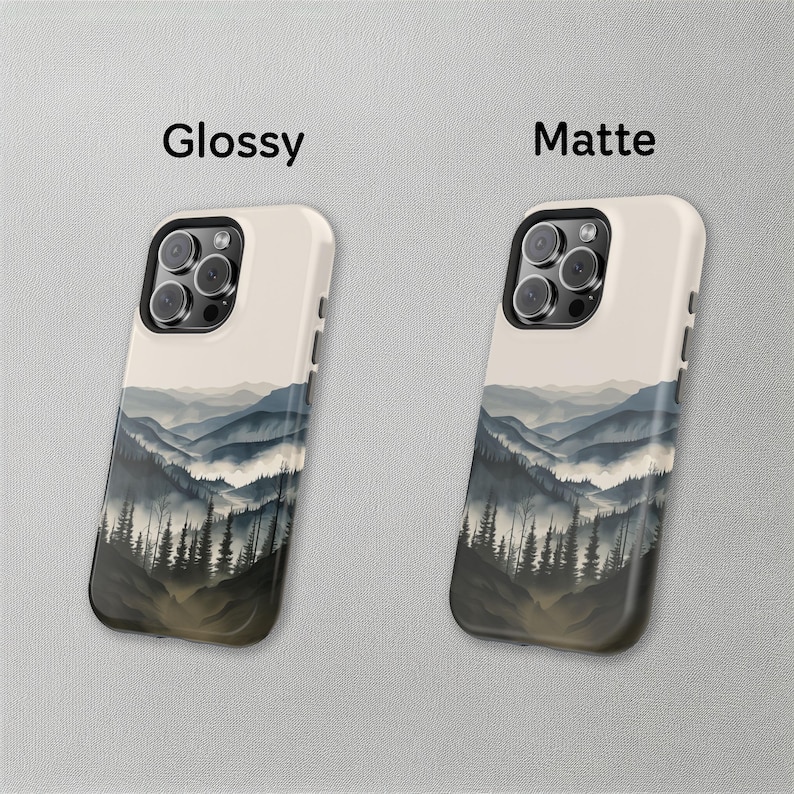 May include: Two phone cases with a mountain landscape design. The case on the left is glossy and the case on the right is matte.