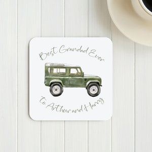 May include: White coaster with a green cartoon jeep and the text "Best Grandad Ever to Arthur and Harry".