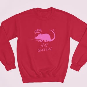 May include: Red sweatshirt with a pink rat wearing a crown and the text "Rat Queen" printed on the front.