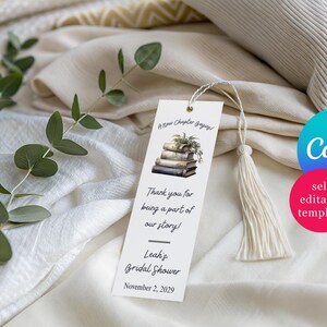 May include: A white bookmark with a tassel, featuring text and a stack of books illustration. The text reads "A New Chapter begins!" and "Thank you for being a part of our story!" with a bridal shower date.