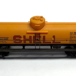 May include: A set of three ceramic mugs with a speckled, matte finish. The mugs are in shades of cream, light gray, and dark gray. Each mug has a simple, minimalist design, perfect for coffee or tea.