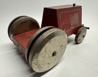 May include: A red toy tractor with silver wheels. The tractor has a number "405" printed on the side.