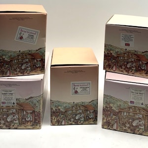 May include: Five boxes with illustrations of different buildings. The boxes are labeled with the names of the buildings, including "The Coal Shed", "Tomkin's Cottage", "Butters Traditions", and "The Village Wood Turner".