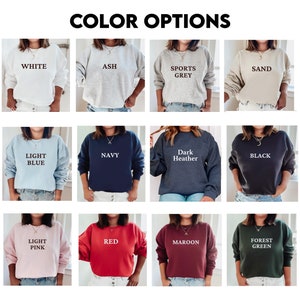 May include: A collage of 12 different color options for a sweatshirt. The colors include white, ash, sports grey, sand, light blue, navy, dark heather, black, light pink, red, maroon, and forest green.