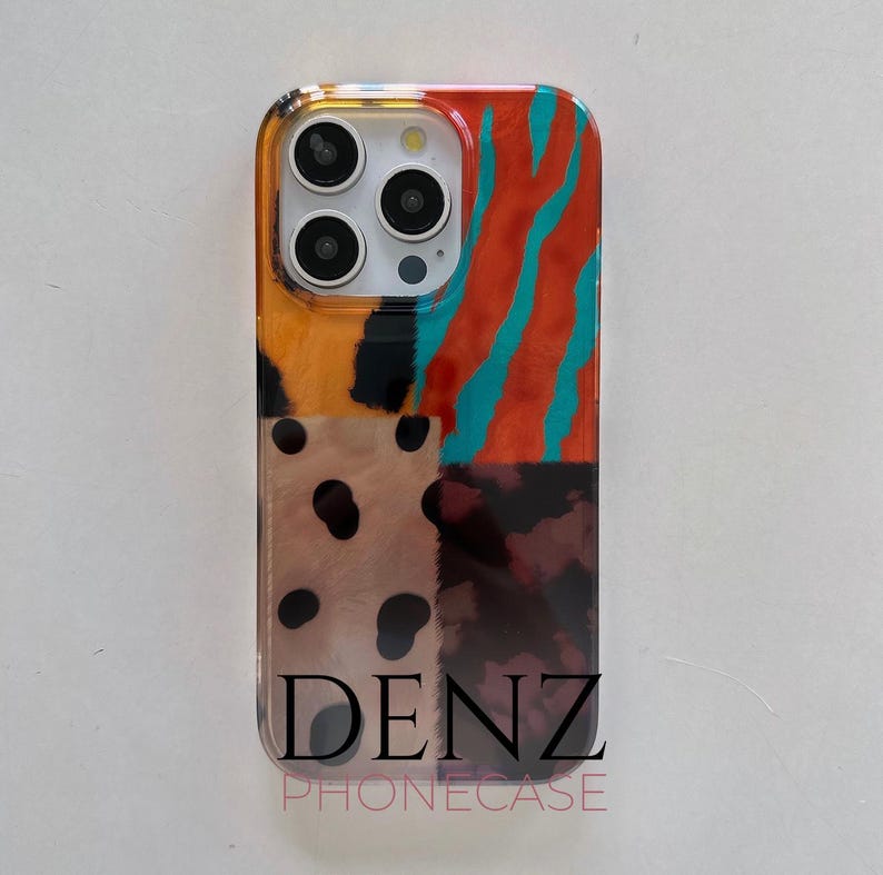 May include: A patterned phone case with a vibrant, abstract design. The case displays a patchwork of patterns, including orange and teal stripes, leopard spots, and a tortoiseshell pattern. The brand name "DENZ PHONECASE" is printed at the bottom.