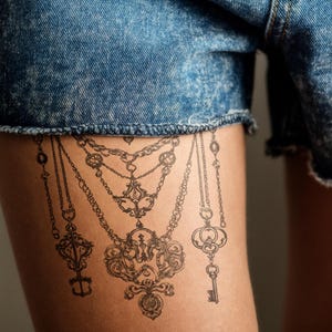 Chain and Key Tattoo, Gothic-Inspired Tattoo, Decorative Ornamented Tattoo, Sophisticated Tattoo Design, Vintage Tattoo, Detailed Ink Tattoo