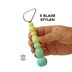 May include: A pottery trimming tool with a metal teardrop-shaped blade and a gradient handle transitioning from light yellow to teal. The handle features a series of rounded, spherical segments. Text on the image reads 5 BLADE STYLES! and MADE IN USA.