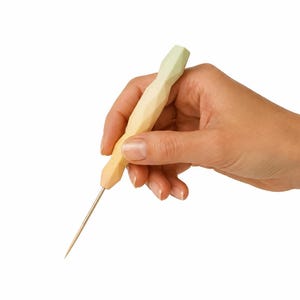 May include: A punch needle tool featuring a faceted, ergonomic handle with a gradient color transition from pale yellow to light green, attached to a thin, pointed metal needle tip, designed for textile crafting and embroidery projects.