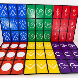 May include: A colorful board game with a grid of square tiles. The tiles are arranged in rows and columns, with each tile featuring a unique symbol in white against a colored background. Colors include blue, green, red, yellow, and purple.