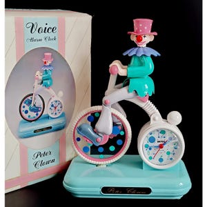Wecker mit Clown auf dem Fahrrad, Originalverpackung, funktionsfähig. Sammlerstück: Tischwecker mit Peter Clown auf dem Fahrrad. Die Zeiger leuchten im Dunkeln.