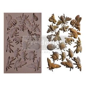 May include: A silicone mould with 18 different bee and beetle shapes. The mould is brown and has a textured surface. The bee and beetle shapes are in various sizes and positions.