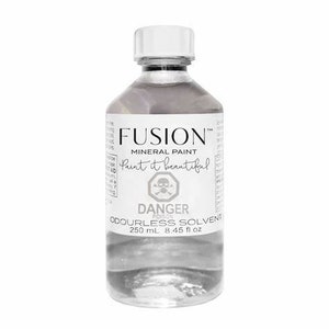 May include: A clear glass bottle with a white label that reads "FUSION™ MINERAL PAINT Paint it beautiful DANGER POISON ODOURLESS SOLVENT 250 mL 8.45 fl oz".