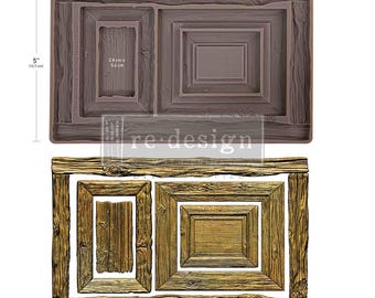 May include: A brown silicone mold for crafting, featuring a rectangular frame design with wood grain textures. The mold measures 8 inches by 5 inches. Below, a gold-colored cast shows the finished product with two distinct frame shapes.